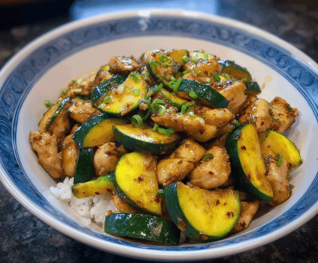 Colorful chicken zucchini stir fry with tender sliced chicken, fresh zucchini, and vibrant vegetables served in a bowl, perfect for a healthy and delicious meal.
