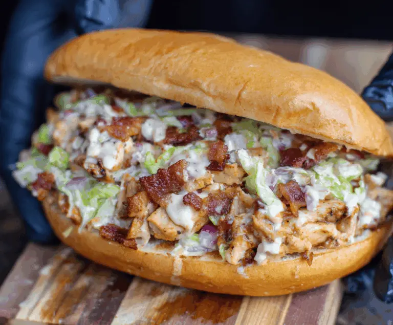 Delicious chopped chicken bacon ranch sandwich with crispy bacon, fresh lettuce, and creamy ranch sauce on toasted bread