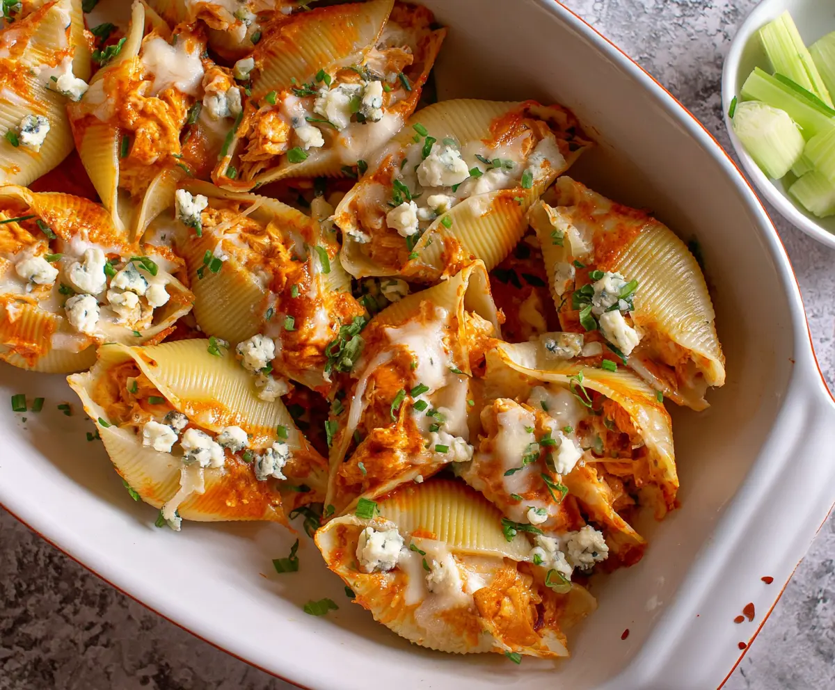 Delicious Buffalo Chicken Stuffed Shells with creamy cheese topping, perfect for dinner.