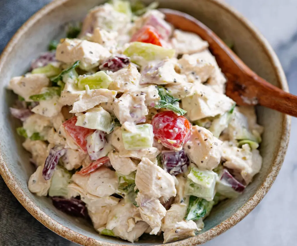 Delicious classic chicken salad with fresh vegetables and herbs, perfect for a healthy meal.