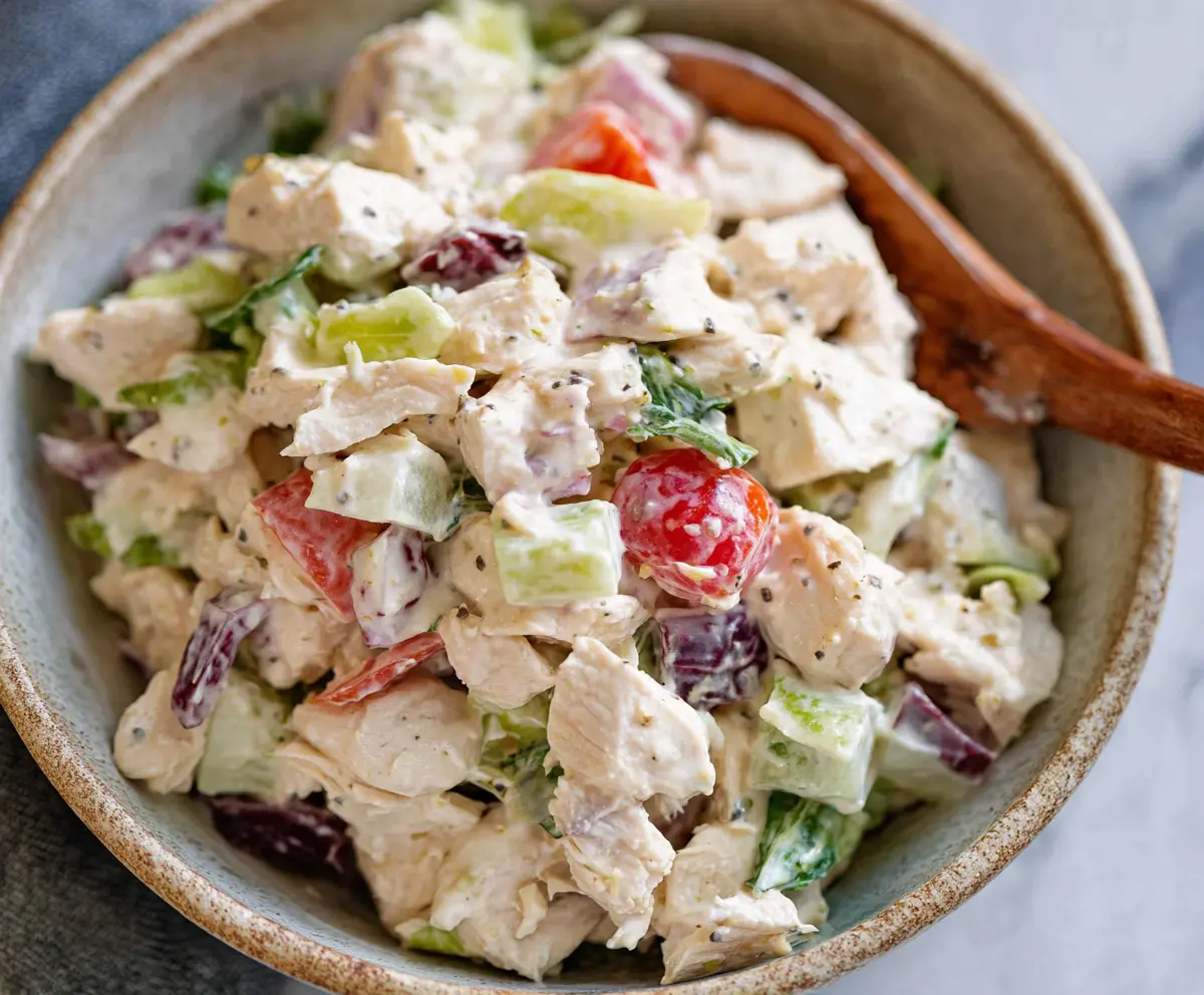 Delicious classic chicken salad with fresh vegetables and herbs, perfect for a healthy meal.