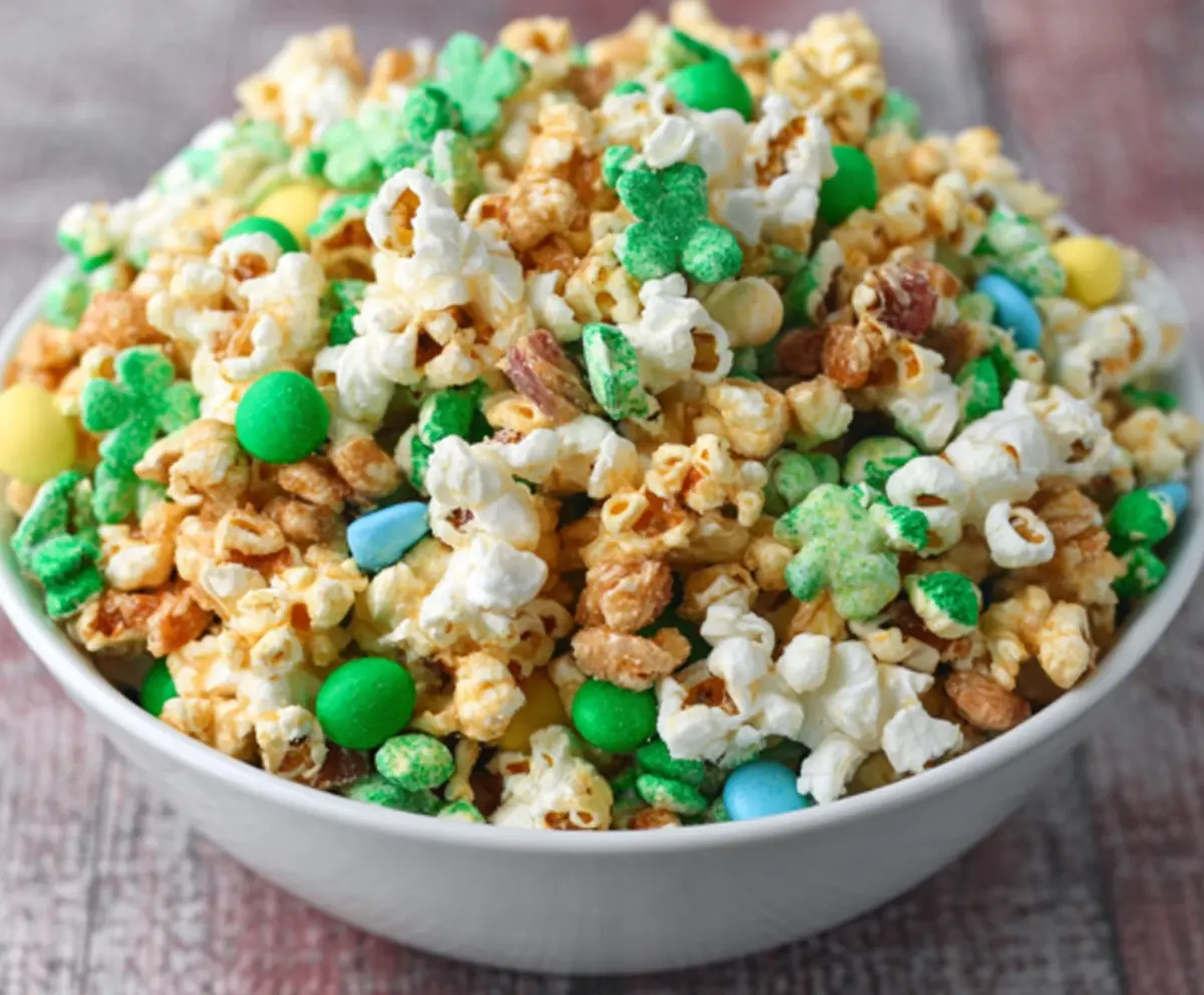 Colorful loaded Leprechaun popcorn decorated with vibrant green, gold, and rainbow toppings for a festive St. Patrick's Day treat.