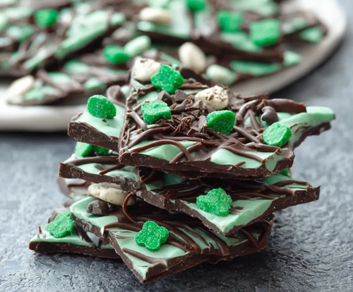 Delicious Mint Chocolate Shamrock Bark topped with fresh mint leaves for St. Patrick's Day celebration.